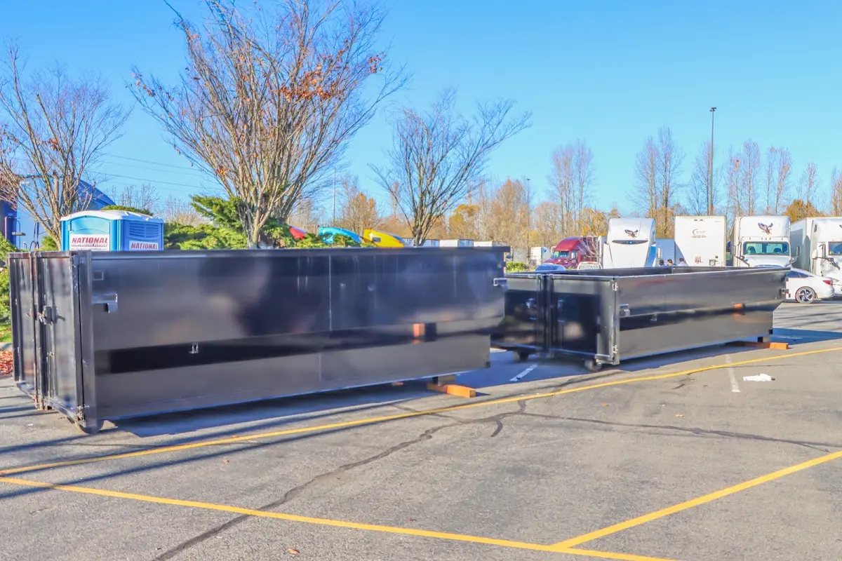 Professional dumpster rental service with roll-off container on residential driveway in Mauldin